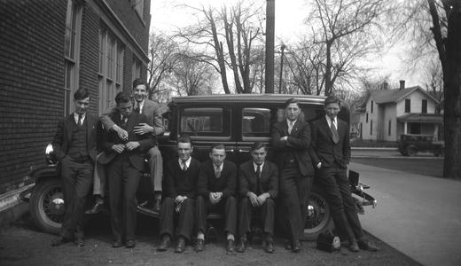 Male students in front of car