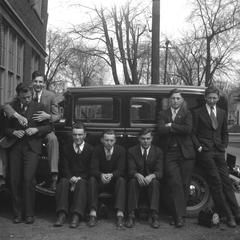 Male students in front of car