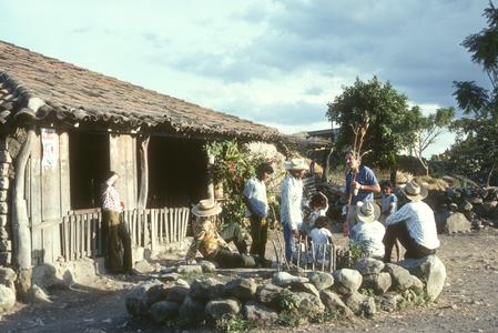 Iltis with teosinte stalk and locals outside of El Progreso