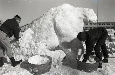 Students working on a snow sculpture