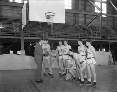 Basketball squad and coach Harold Foster during practice