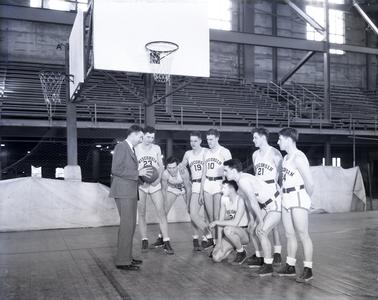 Basketball squad and coach Harold Foster during practice