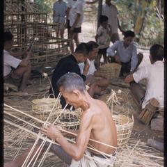 Lao men weaving baskets
