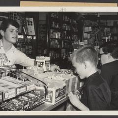 Young boys select candy at a candy counter