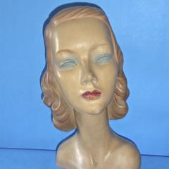 Plaster mannequin with curly brown hair