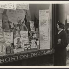 A woman looks at a pharmacy window display
