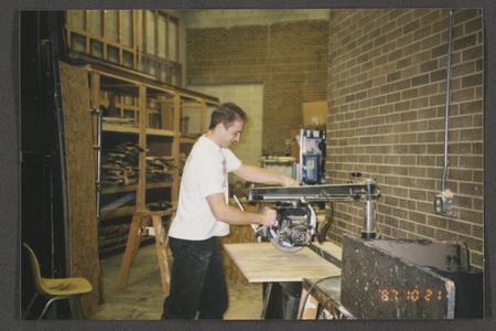 Student using circular saw in shop area
