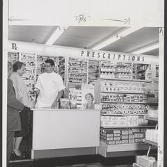 A pharmacist assists two shoppers