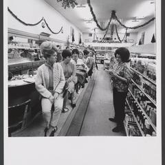 Women sit at drugstore lunch counter