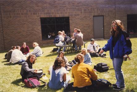 Students studying on grass in courtyard