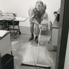 Chancellor Edward W. Weidner wielding a mop