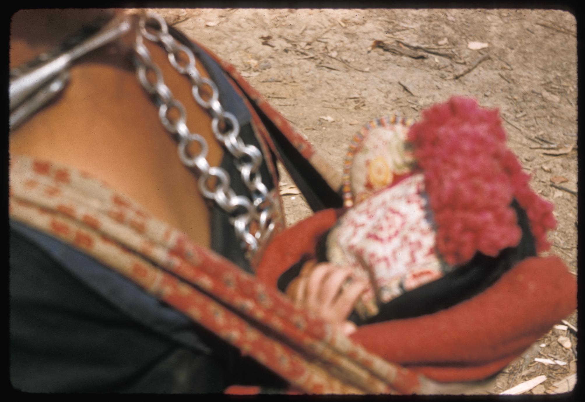 Hmong (Meo) spectator with baby
