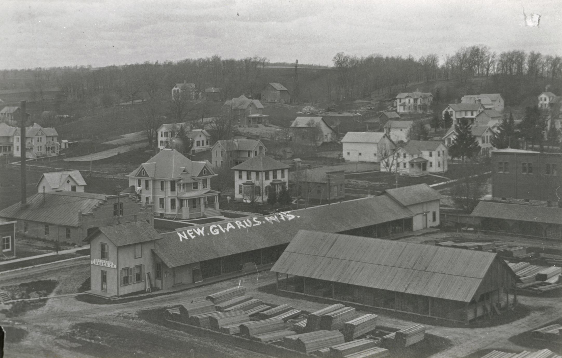 ‎Lumberyard and houses, New Glarus UWDC UWMadison Libraries