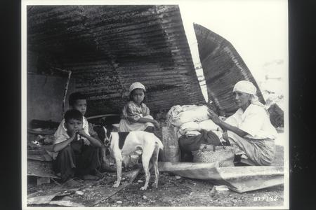 Filipino family sheltered beneath the rubble of their former home, Pasay, 1945
