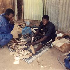 Leatherworker Prepares Straps to Hold Strings of the Ngoni