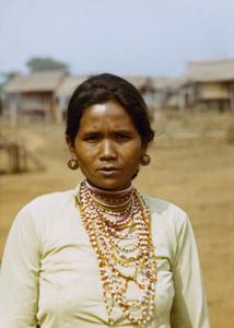 Nyaheun wife of the village chief poses in a village in Attapu Province