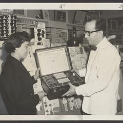 A customer learns how to use a TV tube tester
