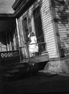 Woman sitting on porch of Burlington home