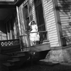Woman sitting on porch of Burlington home