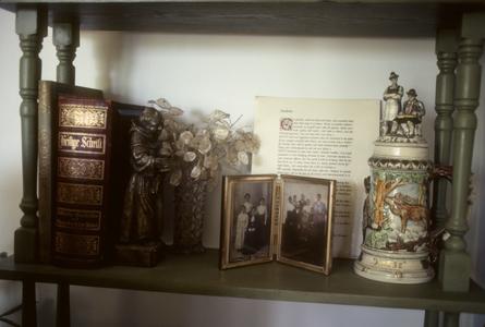 Bible, beer stein, and family portrait on mantelpiece