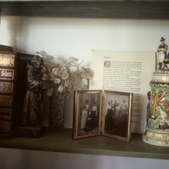 Bible, beer stein, and family portrait on mantelpiece
