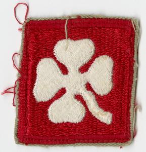 Red diamond with a four leaf clover badge