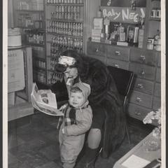 A woman and her child wait in a pharmacy baby department