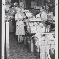 A woman examines baby products in a drugstore display