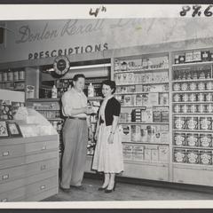 Customers view products in the pharmacy section of a drugstore