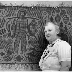 Helen Louise Allen in front of a tapestry