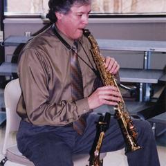 Music professor Dan Ackley playing a soprano saxophone