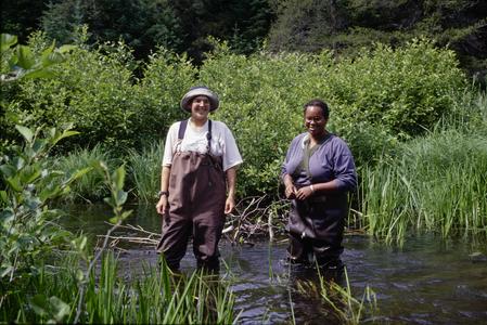 Amina Pollard and Kelly Melville standing in the Rive Creek outlet of Little Crooked Lake