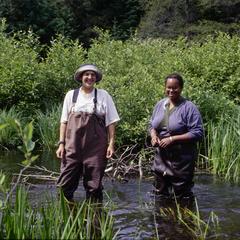Amina Pollard and Kelly Melville standing in the Rive Creek outlet of Little Crooked Lake