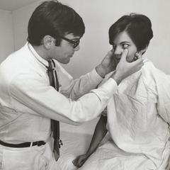 Ophthalmologist examines patient