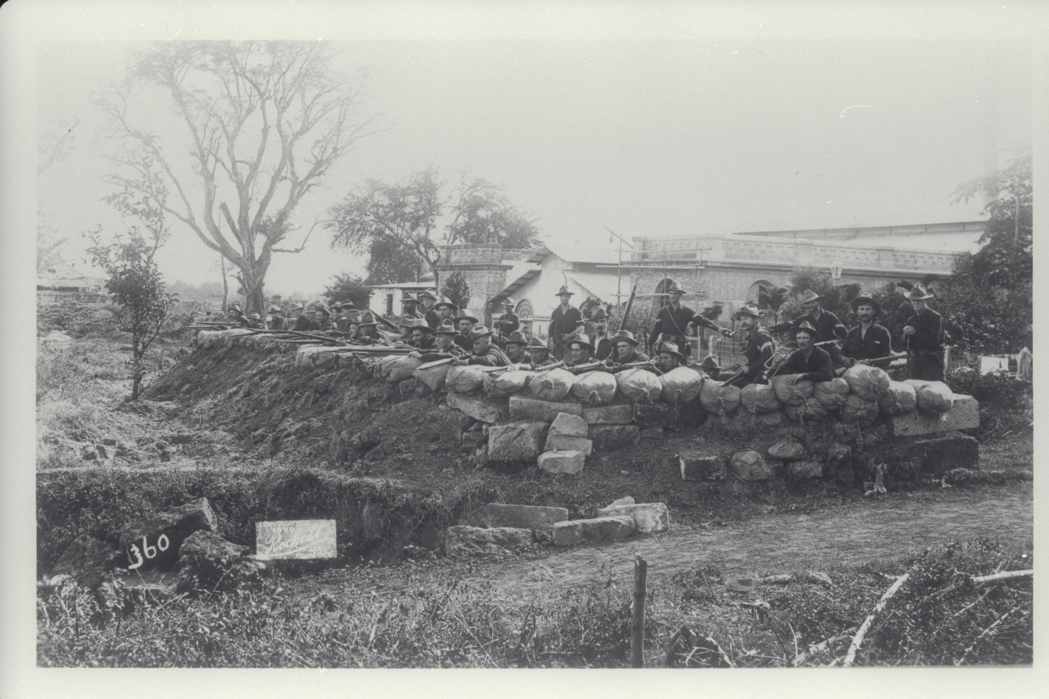 Company of American soldiers dug into defensive position at the Antohan pumping station, 1899