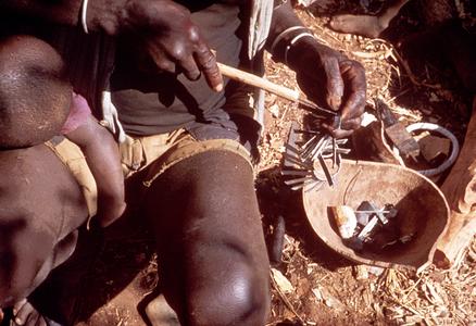 Metal Worker Incising Designs on Strips of a Kamba Aluminum Necklace