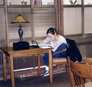 Student studying at a table in 2004