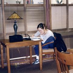 Student studying at a table in 2004