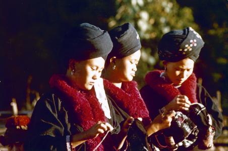 Three Yao (Iu Mien) women embroidering in the village of Houei Lai in Houa Khong Province