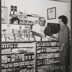A pharmacist assists a customer