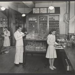 Pharmacy staff at work compounding prescriptions