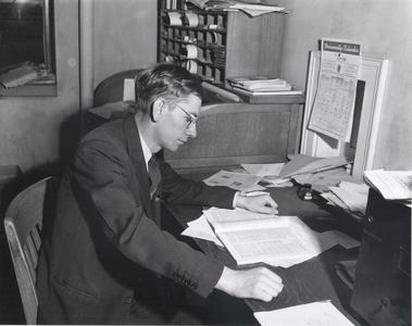 Edwin Young reads at a desk