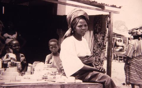 Mrs. Oluyemi sitting at a market stand