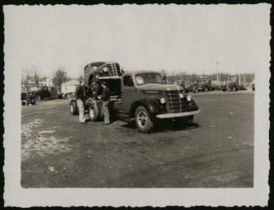 A tow truck loaded with a Nash automobile