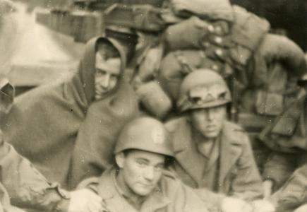 American soldiers traveling in the back of a truck on a cold day
