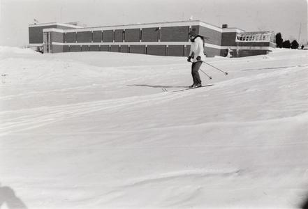 Student skiing on campus