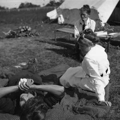 Women reclining near tent