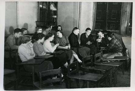 Stout Student Association members sitting at classroom desks and talking