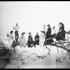 "Blackbirds" - group of men and women on fallen tree