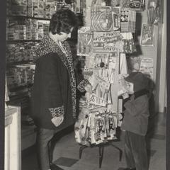 A woman and her son examine a display of toy tools